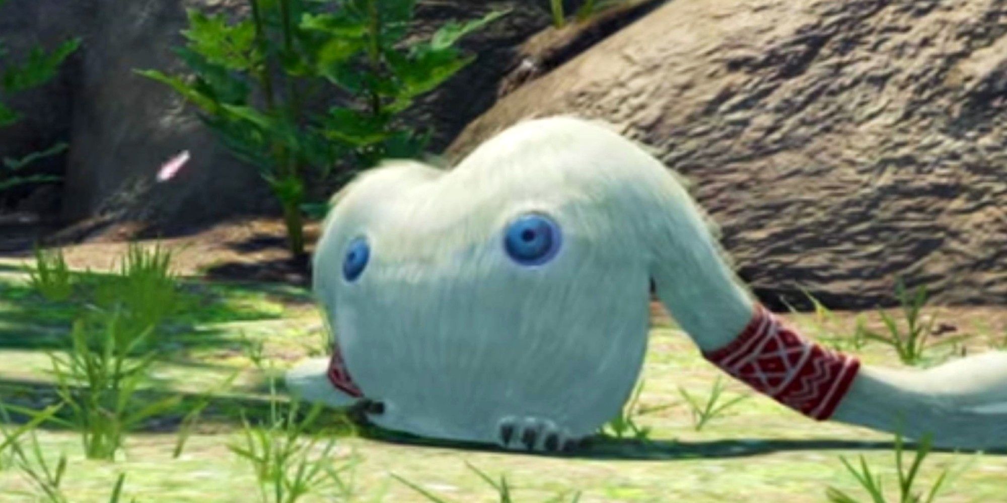 Mamuta standing in some grass with its left arm dragging behind him