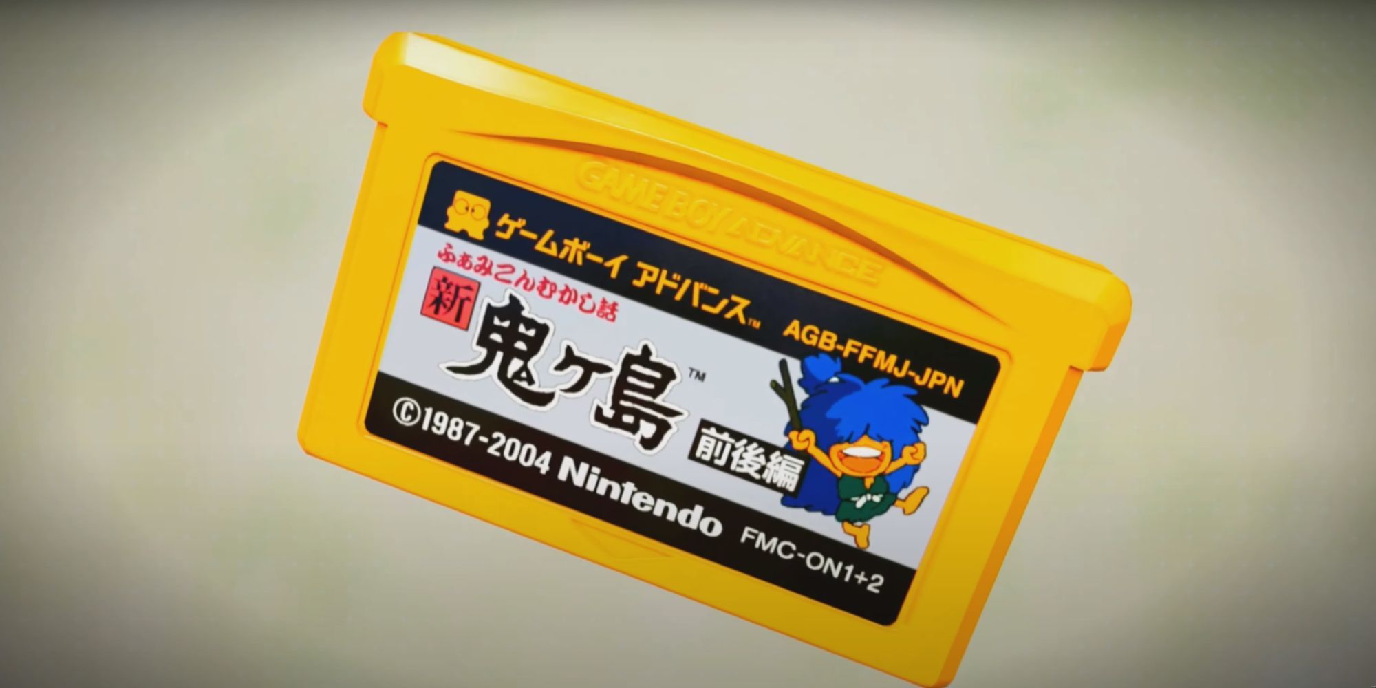An image of a yellow GBA cartridge with Japanese text and a character with blue hair.