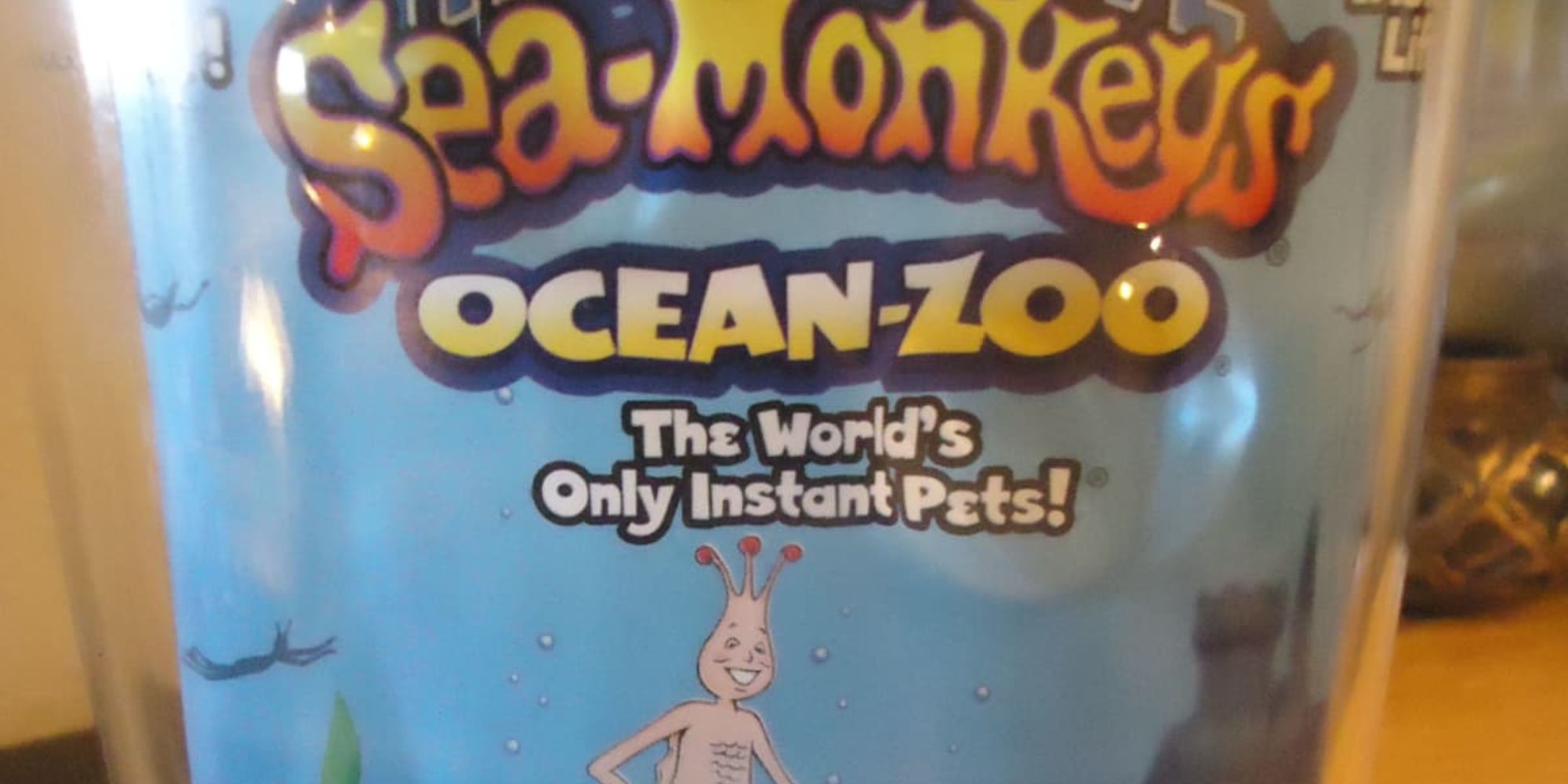 retro package of sea monkeys with artist design of sea monkey on front