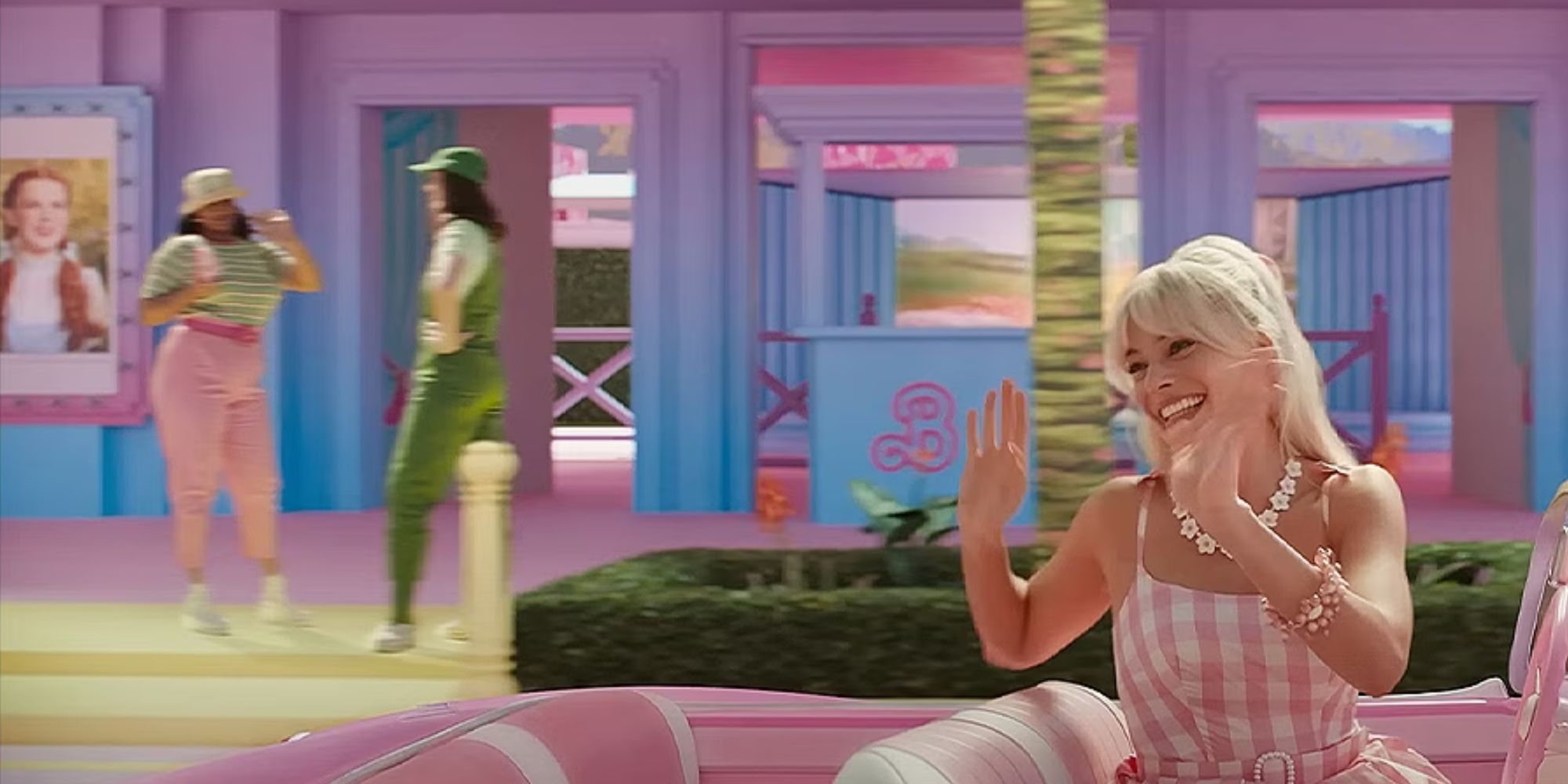 Barbie in her car with Wizard of Oz movie posters in the background