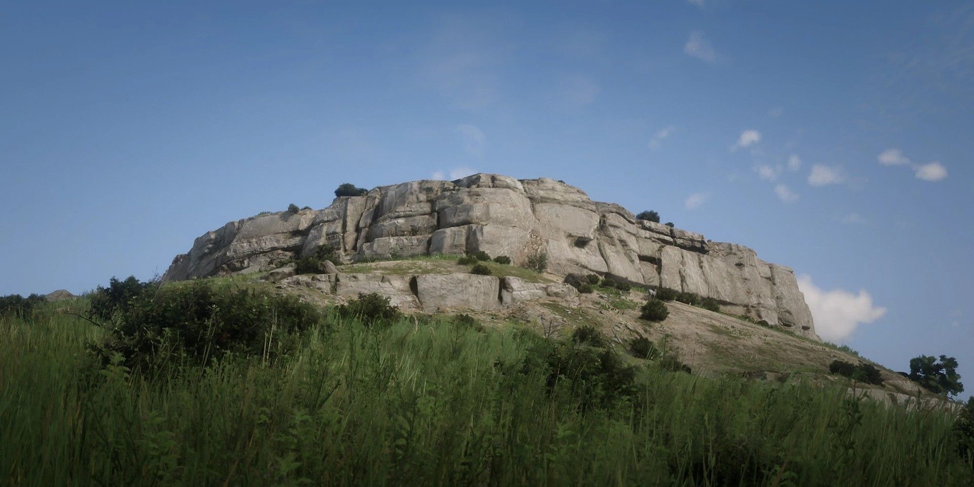 Citadel Rock is visible in the middle of the field with a clear blue sky in the background