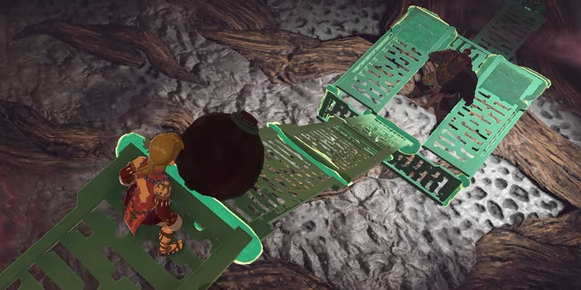 Tears of the Kingdom screenshot of Ganandorf in a pen while Link prepares to roll a bomb down a ramp, aimed at his head