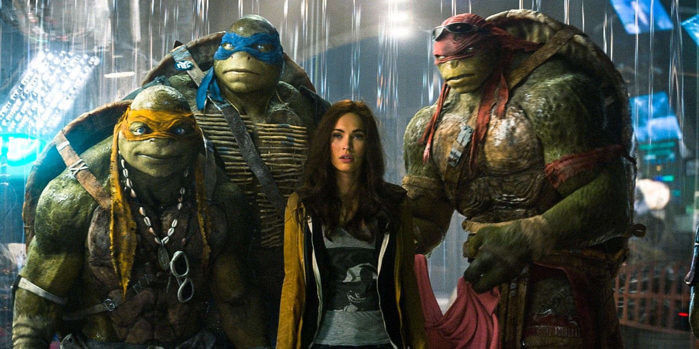 April O'Neil stands with the Ninja Turtles