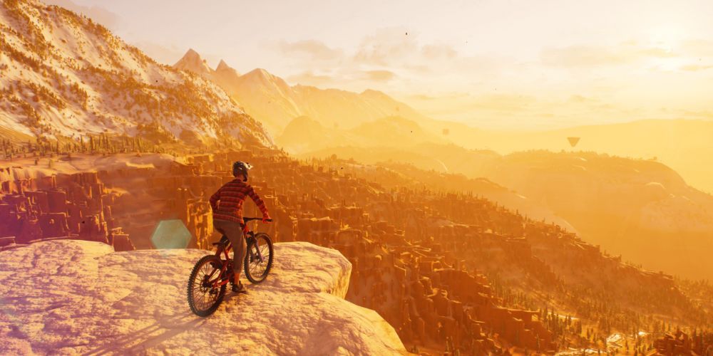 Rider watching the sunset on top of a cliff