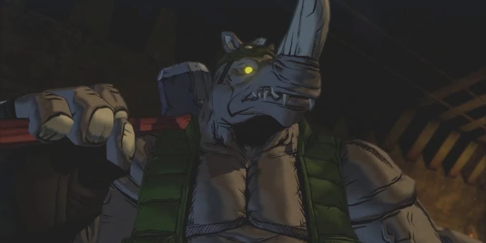 Rocksteady stands in the sewer with a giant hammer resting on his shoulder in TMNT.