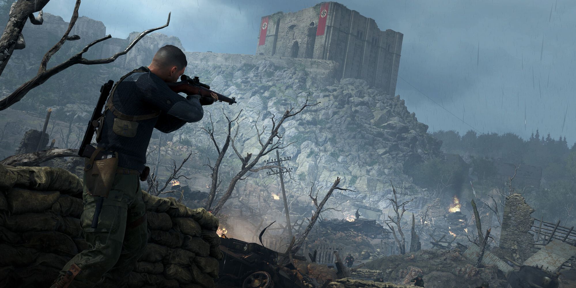 Sniper Elite 5 Screenshot Of Conqueror DLC Mission Showing Karl Aiming His Rifle With Rubble And Castle In Background