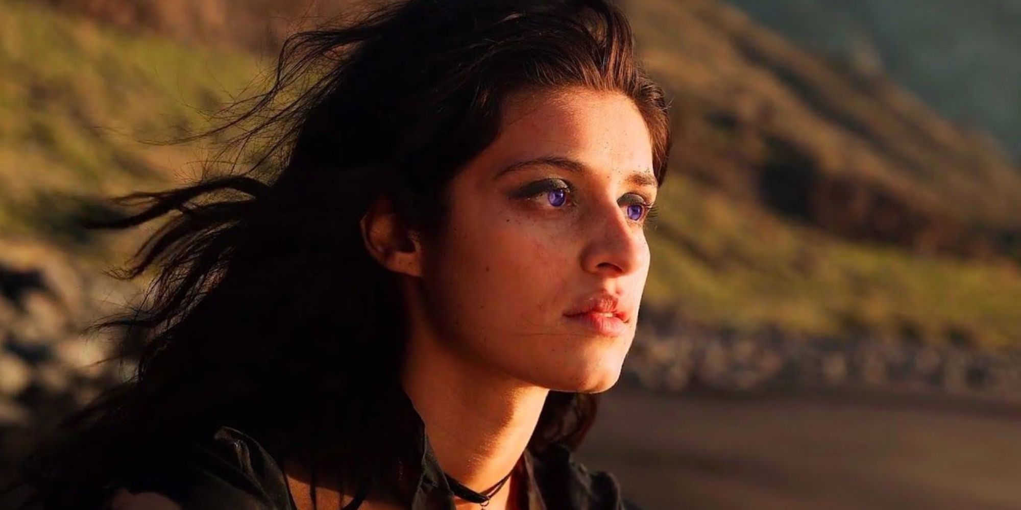 The Witcher Screenshot Of Yennefer Sat On Beach, Starring At Ocean