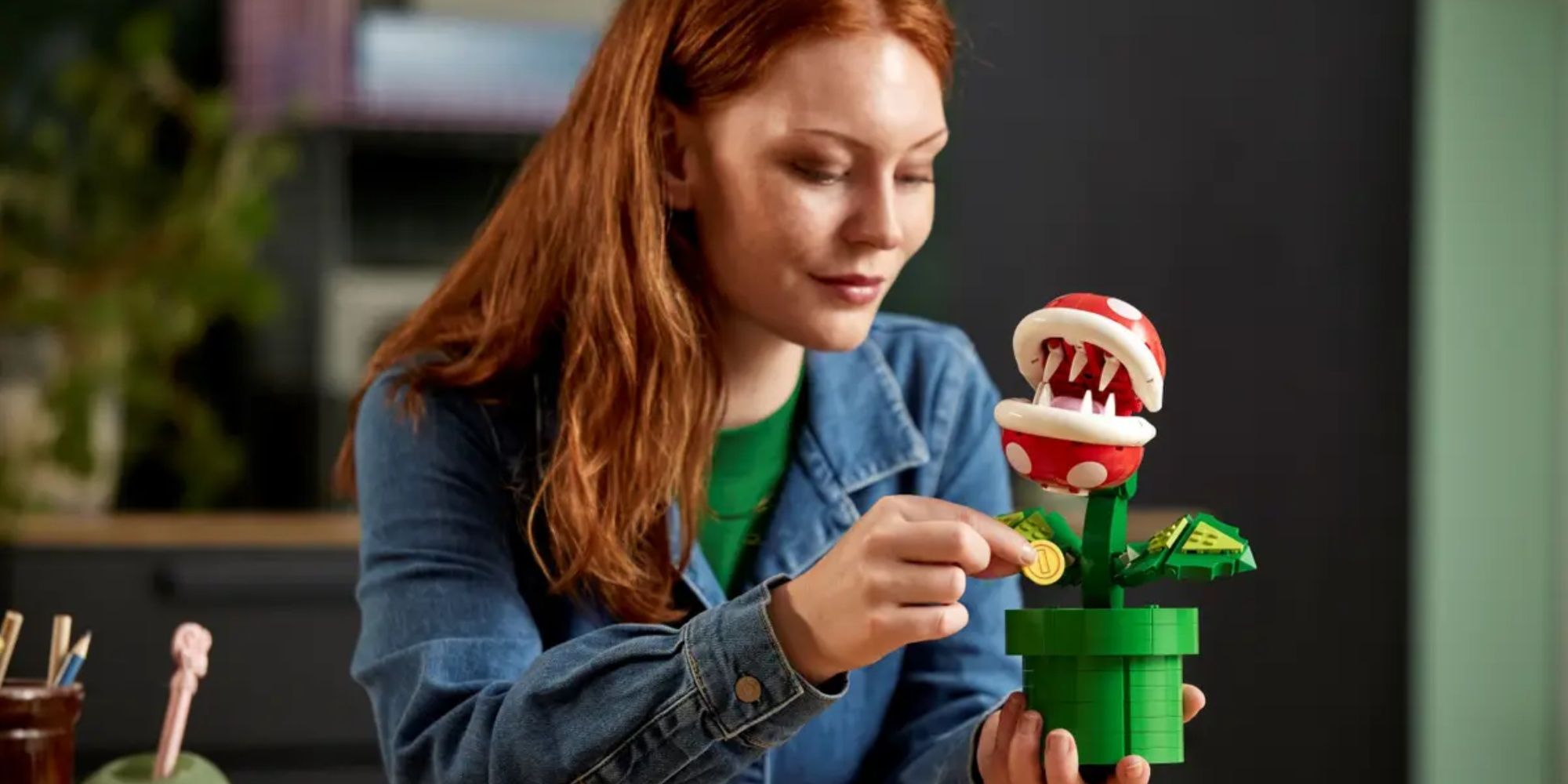 somone putting a coin in the lego piranha plant set