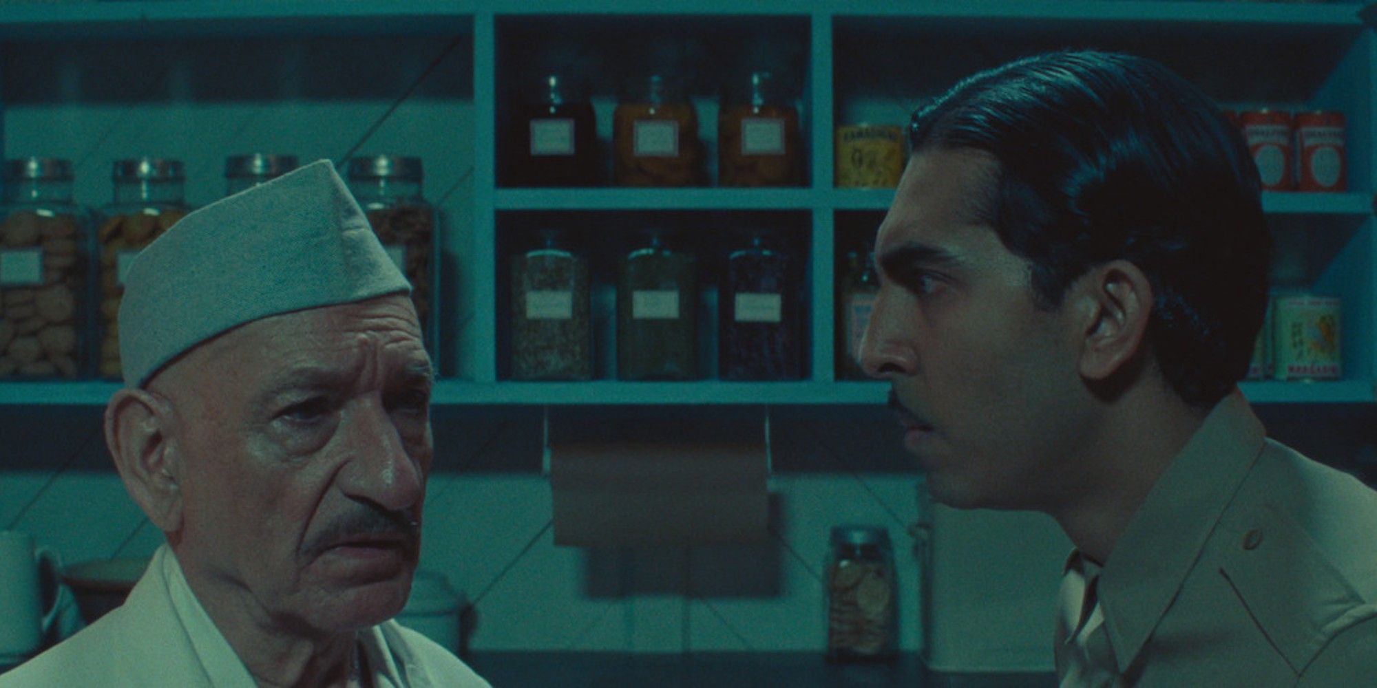 Dev Patel Stares at a melancholy looking Ben Kingsley in Poison