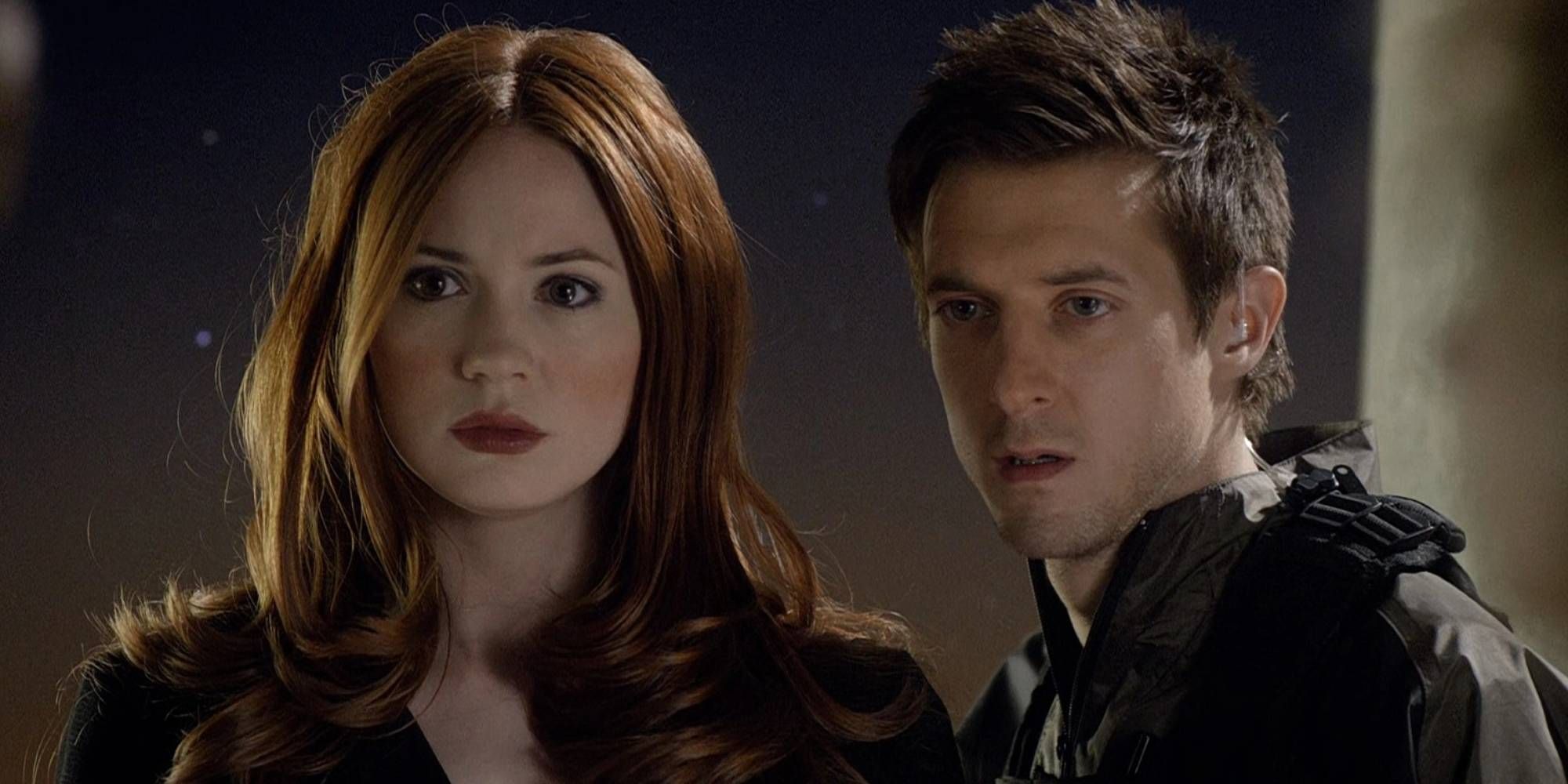 A ginger woman and brown haired man standing together