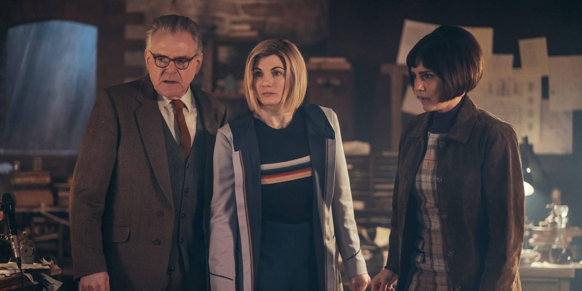 The Doctor, an older man and adult brunette woman standing in a messy office