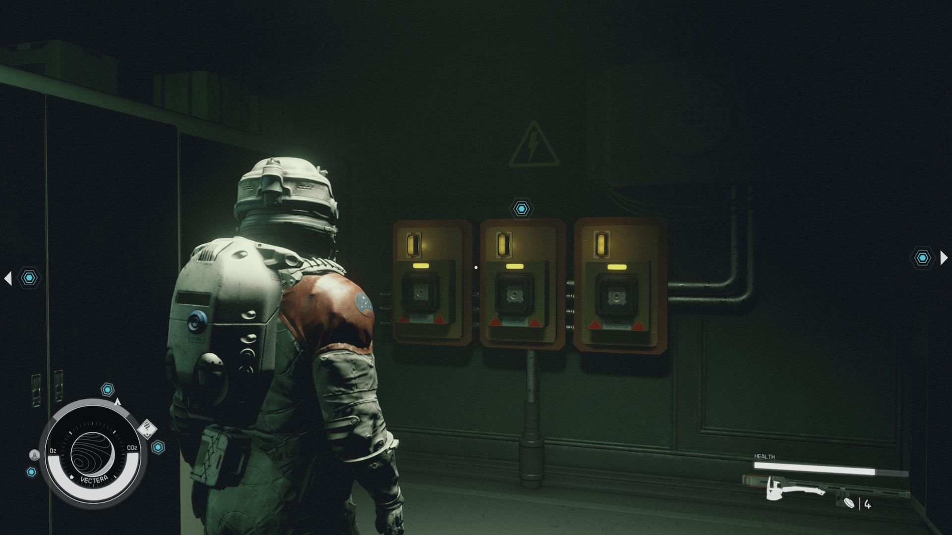 A person in a spacesuit looking at an electrical outlet on the wall that needs power cells,