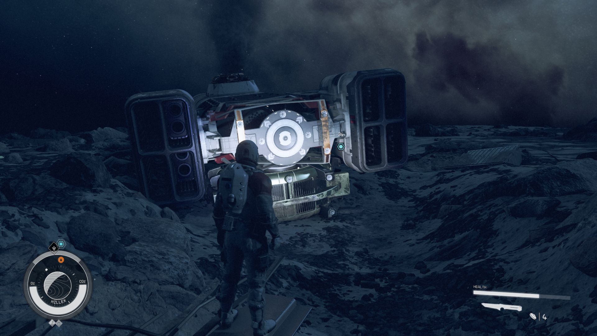 A person in a spacesuit shines a light on the wreckage of a crash space ship.