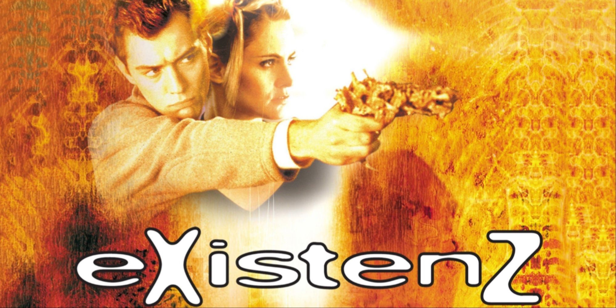 Cover art for David Cronenberg's movie Existenz with Jude Law beside Jennifer Jason-Leigh aiming a sci-fi weapon.