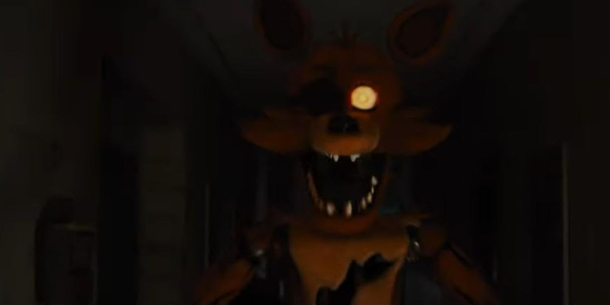 Foxy emerging from the darkness with yellow eyes about to attack Jeff.