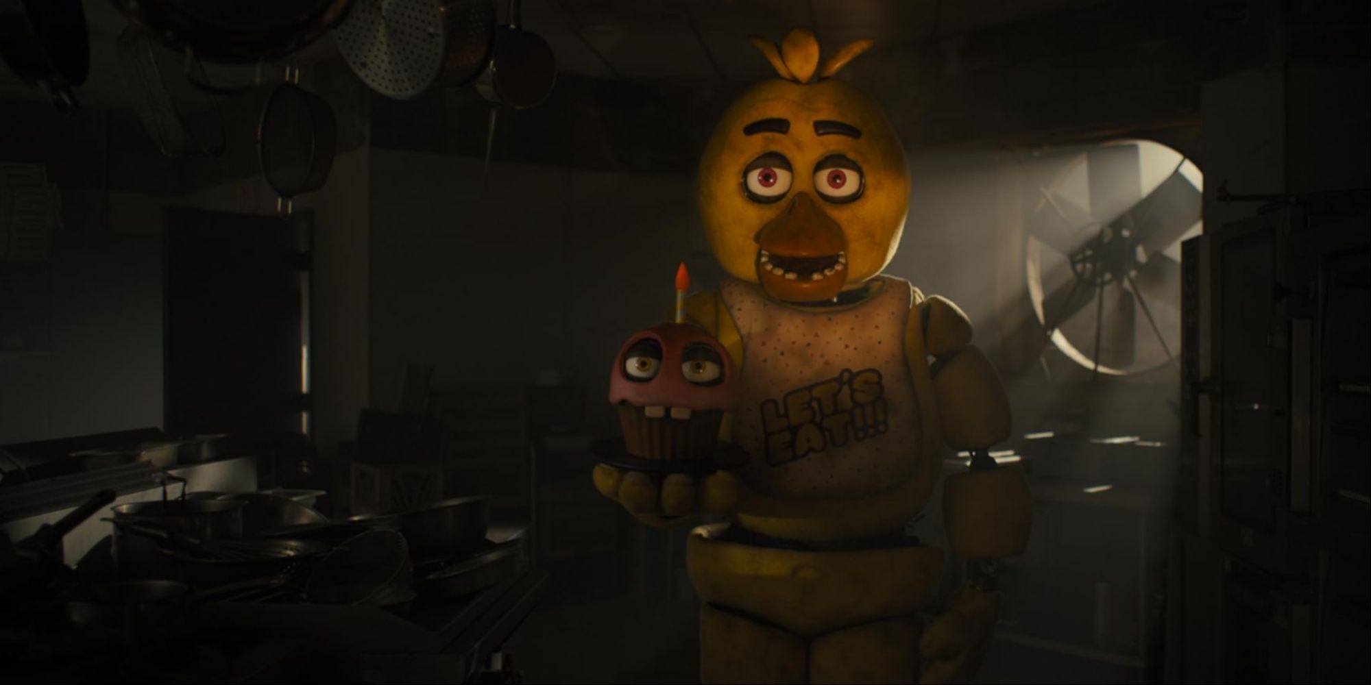 Chica holding Cupcake while standing in the middle of the kitchen as a jumpscare setpiece.