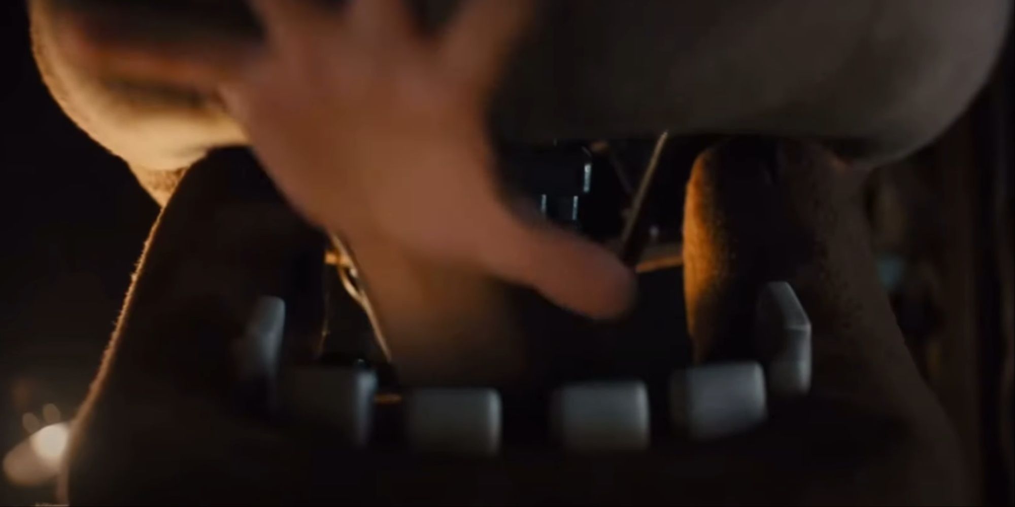 A hand reaching out from the mouth of the Freddy Fazbear animatronic as part of an intense jumpscare.