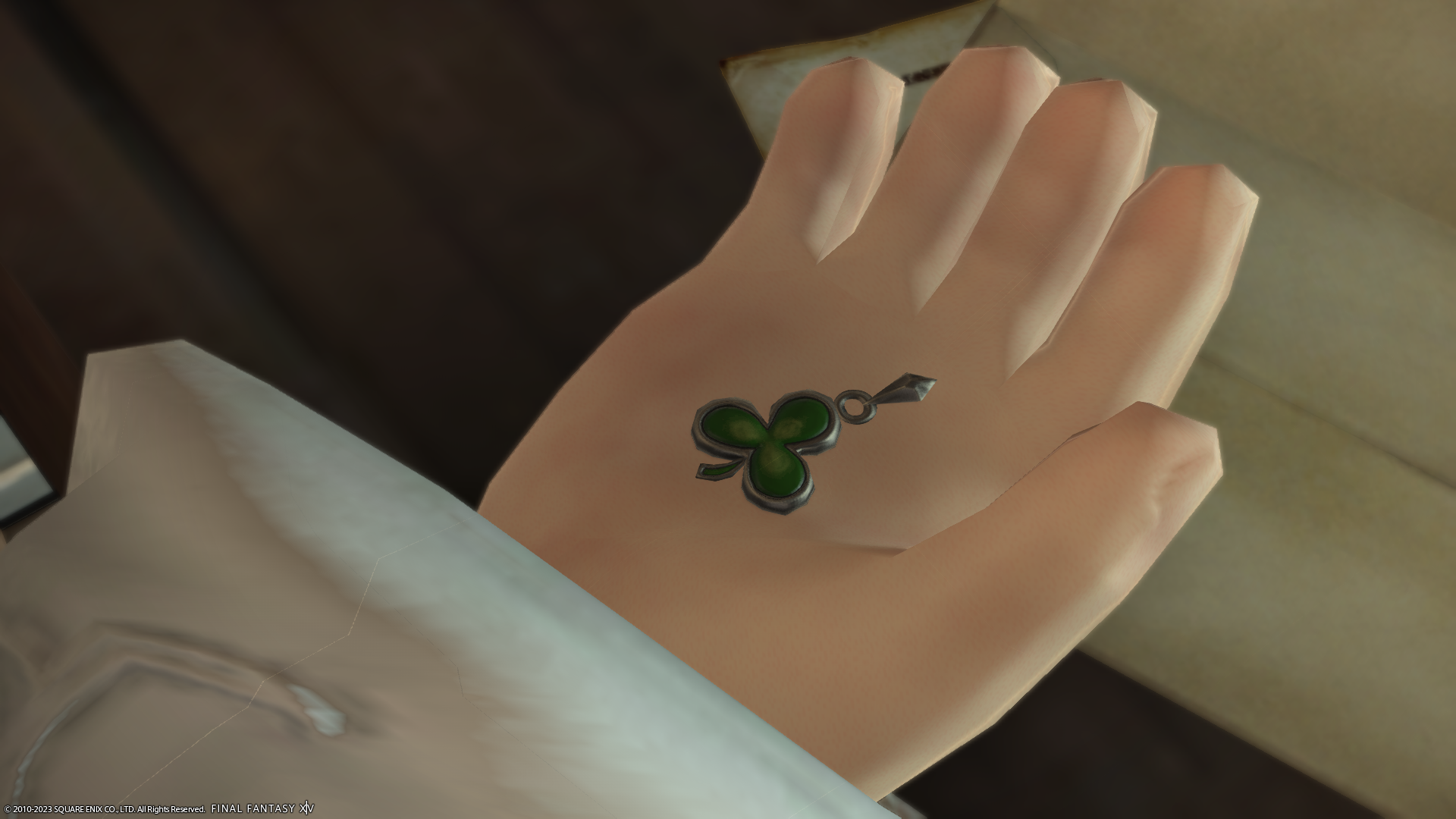 Krile holding a three leaf clover earring in the palm of her hand in Final Fantasy 14