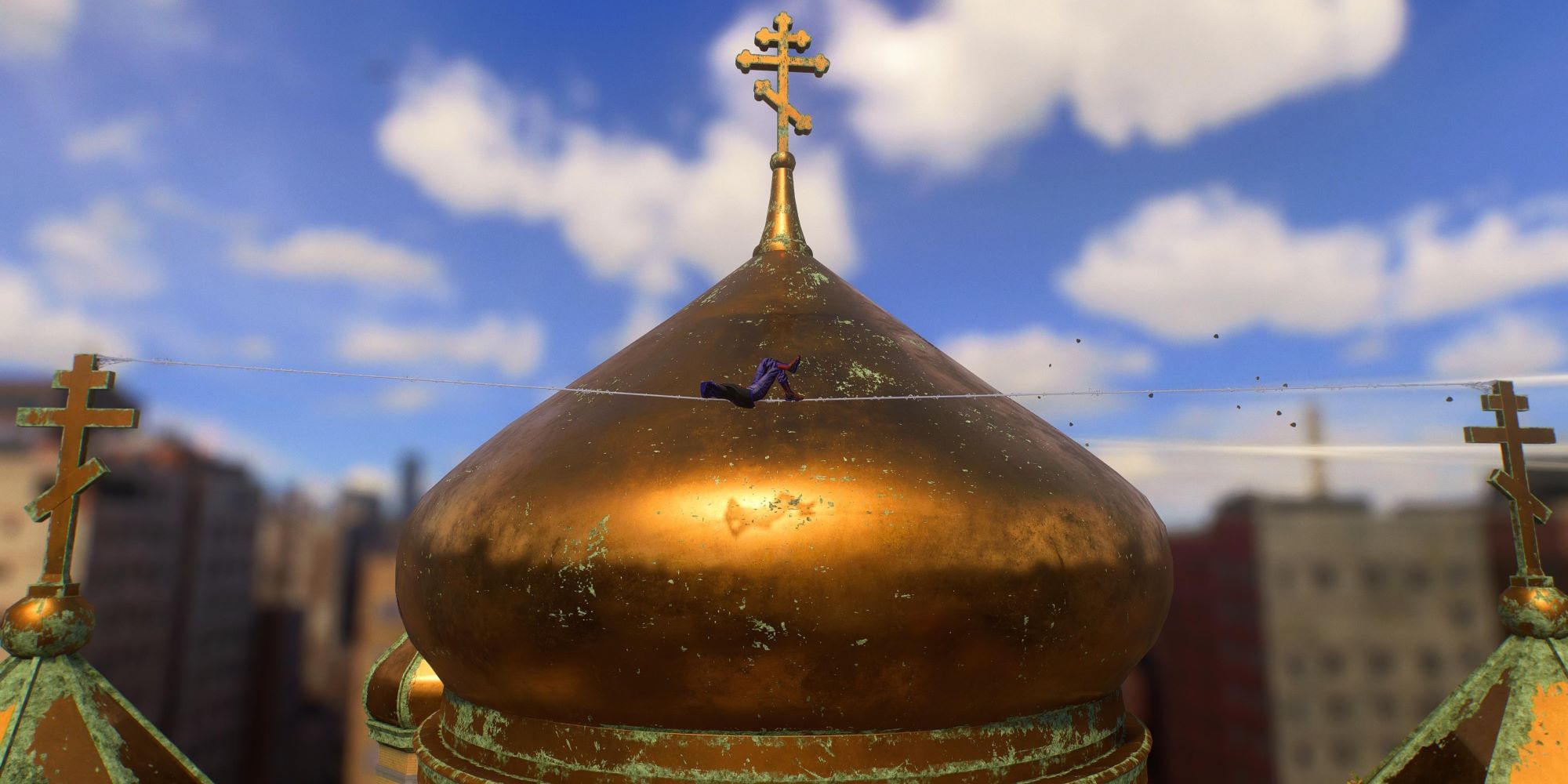 Marvel's Spider-Man 2 Miles relaxing on a web wire above the Little Odessa golden church