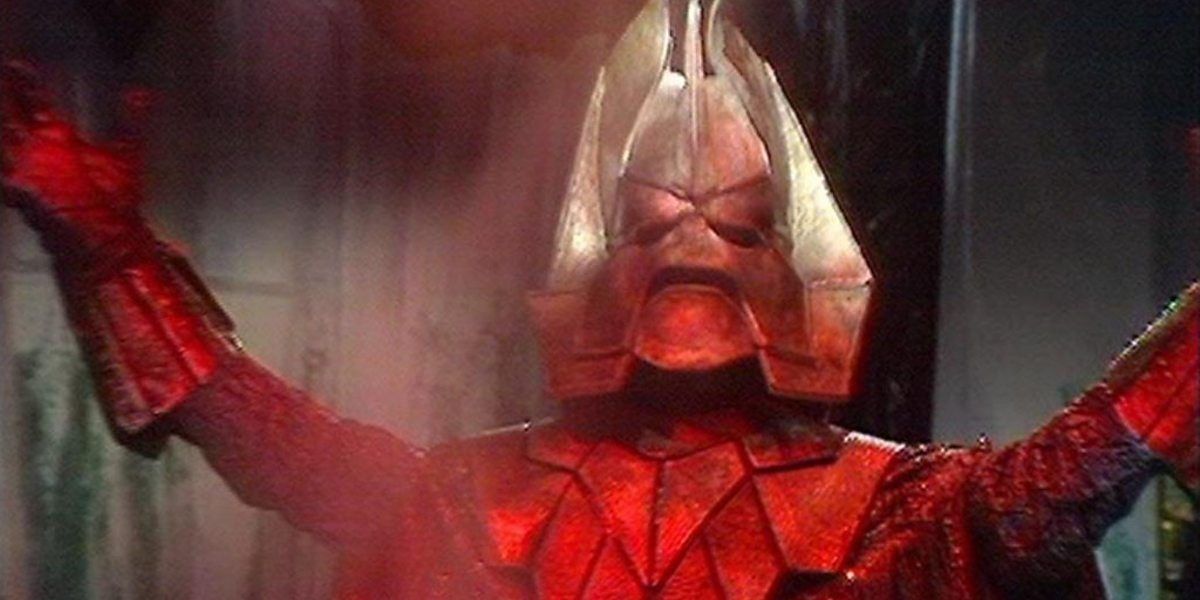 Doctor Who's Omega, founding Time Lord holds his arms aloft triumphantly