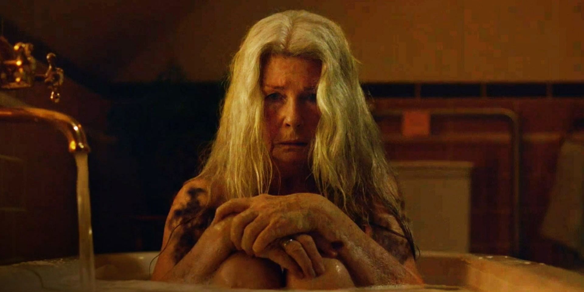 Relic - Edna sits in the bath with black spots covering her arms