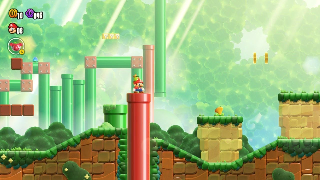 Mario standing on a red pipe that leads to a red pipe in the background.