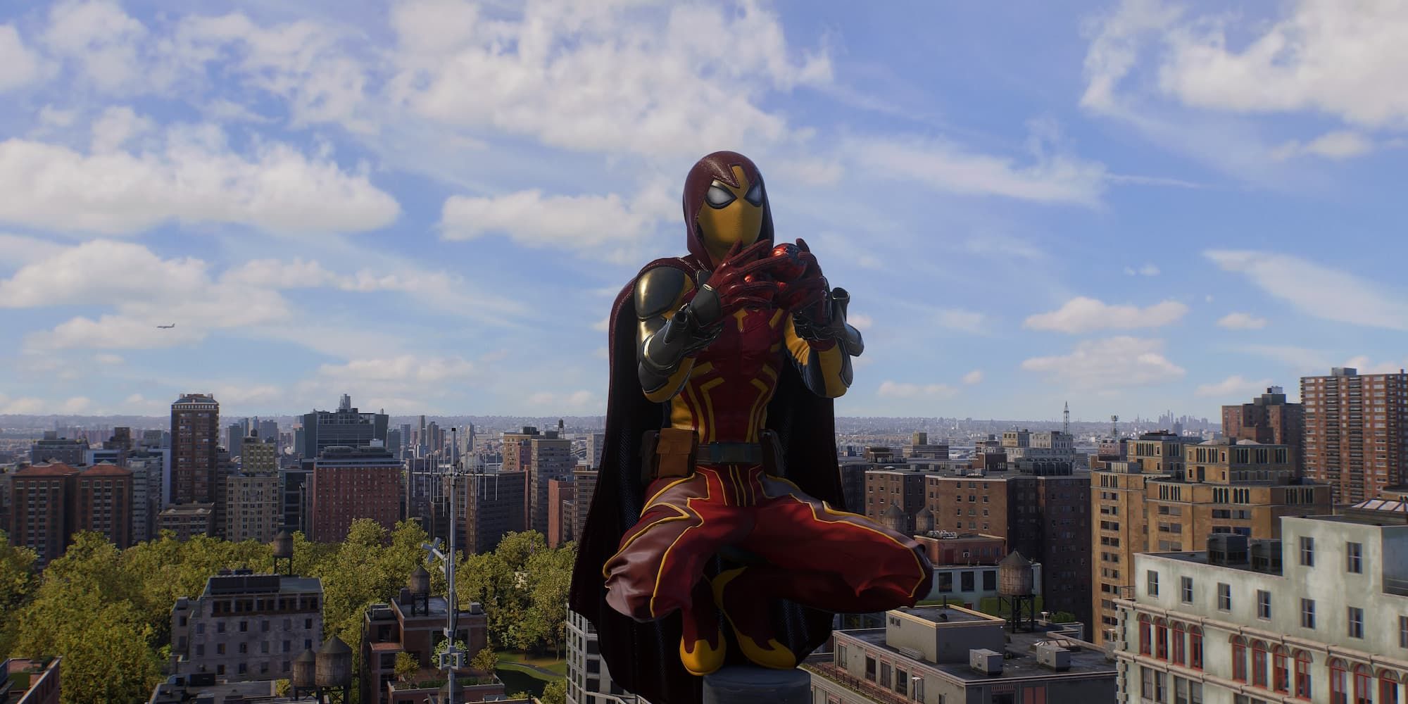 Spider-Man juggles atop a building in his yellow and red Arachknight Suit in Spider-Man 2.