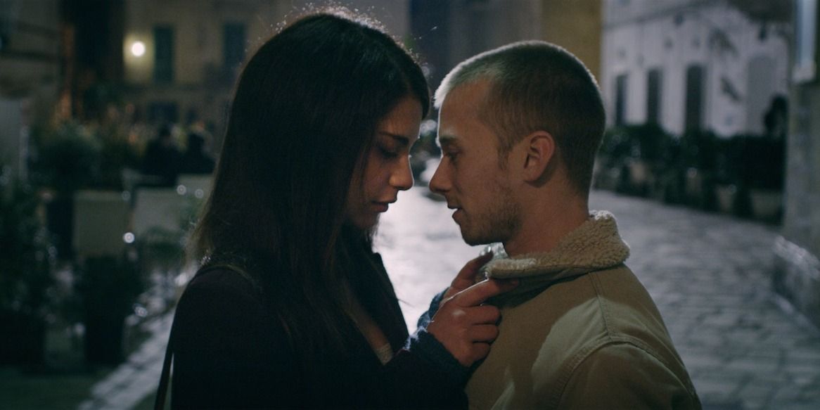 Spring - Louisa holds Evan's coat collar in a passionate encounter