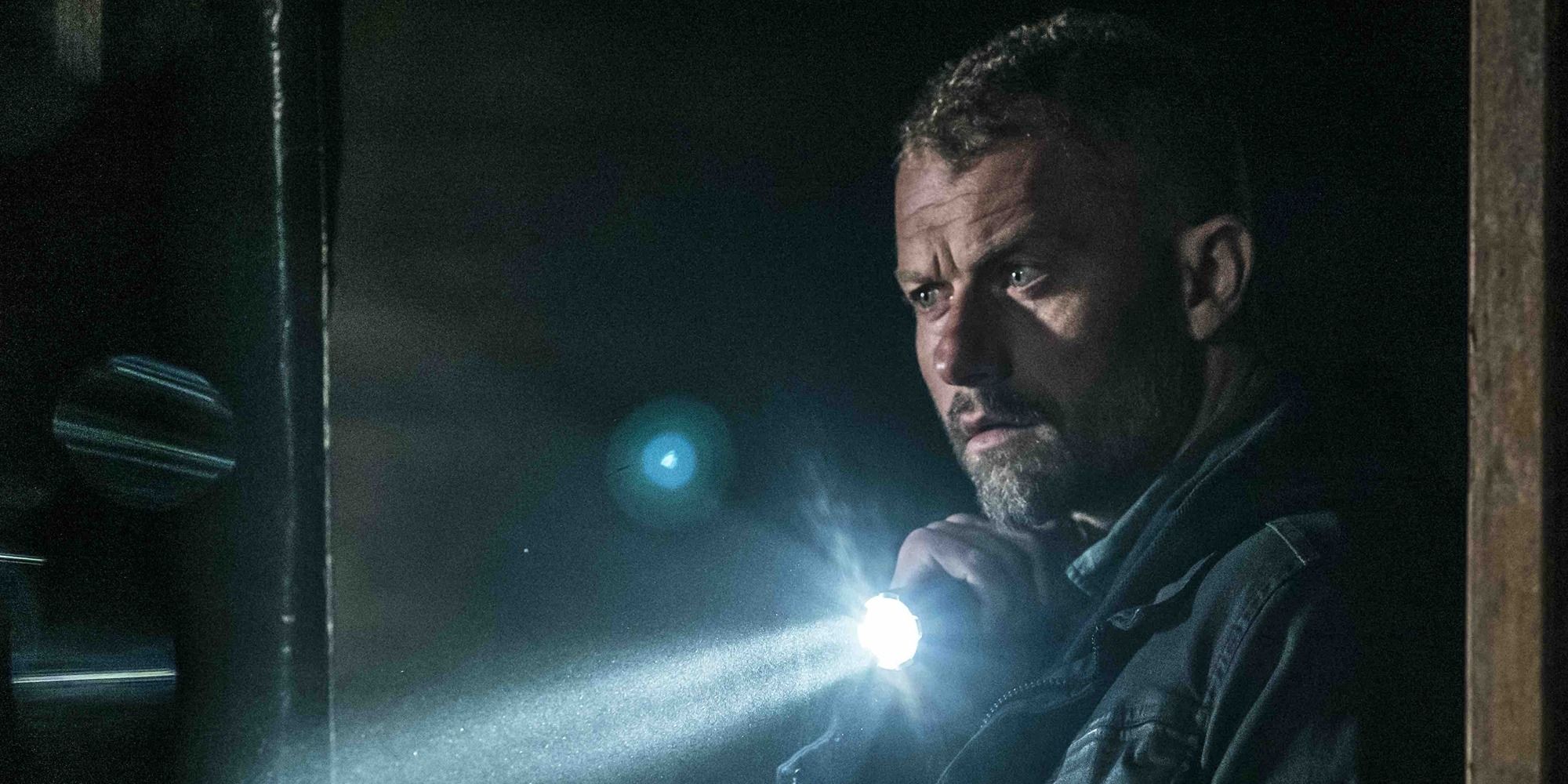 The Empty Man - James searching a dark room with a flashlight