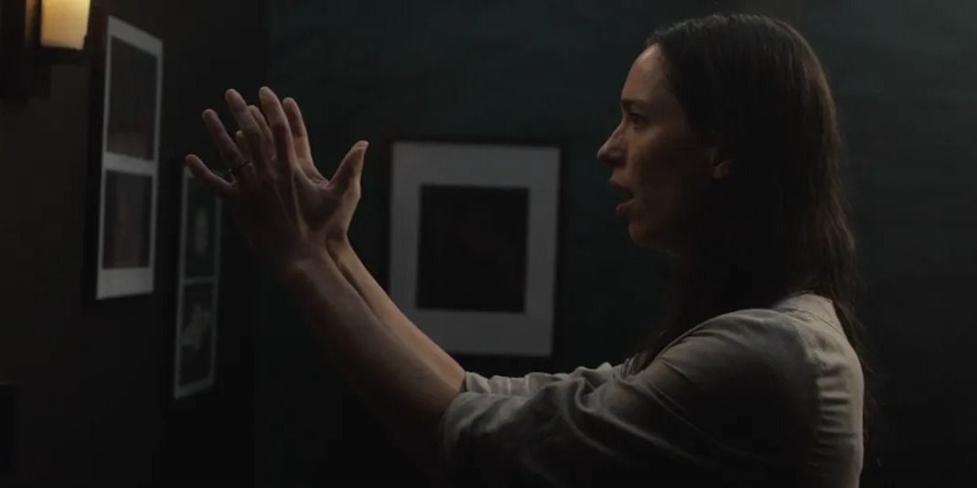 The Night House - Beth holding her hands out to touch something invisible