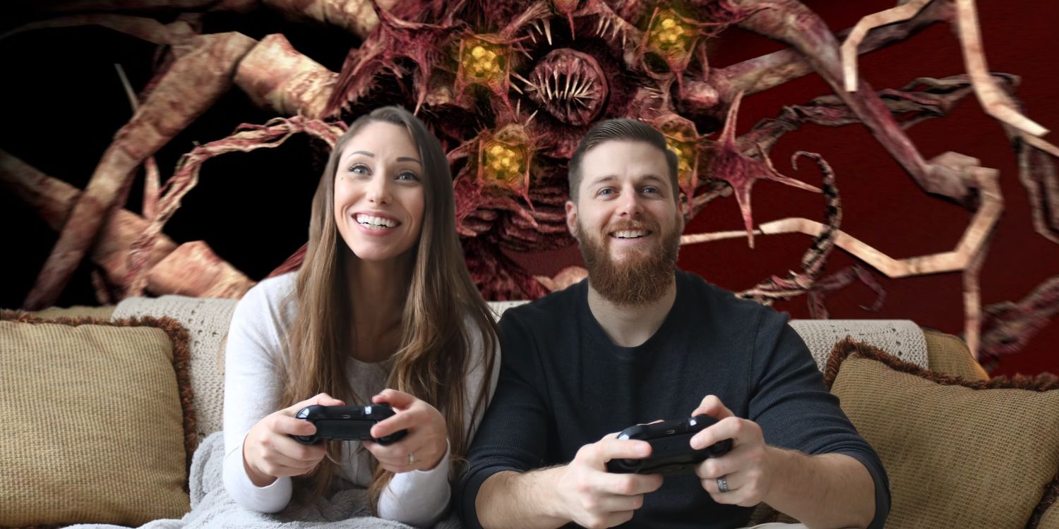 Two people sitting on a couch gaming while a monster from Dead Space looms behind them