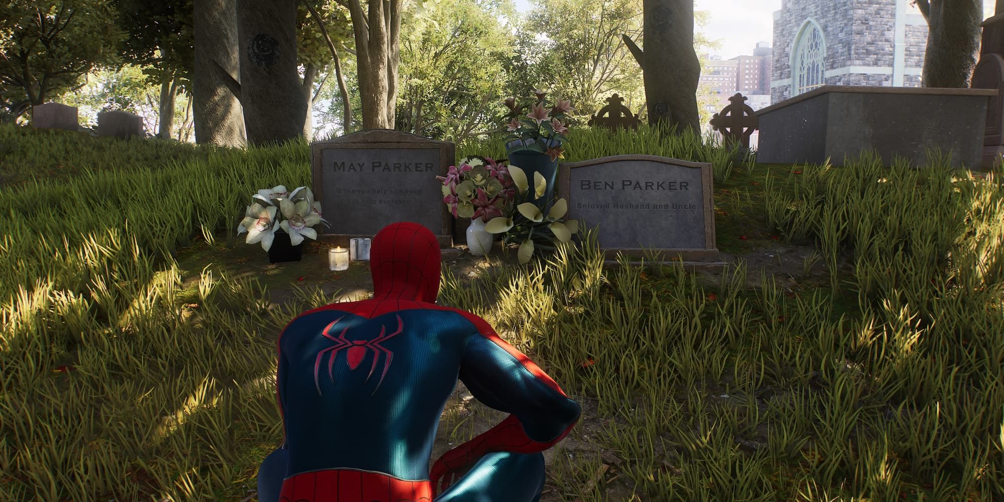 Spider-Man squats on the ground in front of the graves of Uncle Ben and Aunt May in Spider-Man 2.