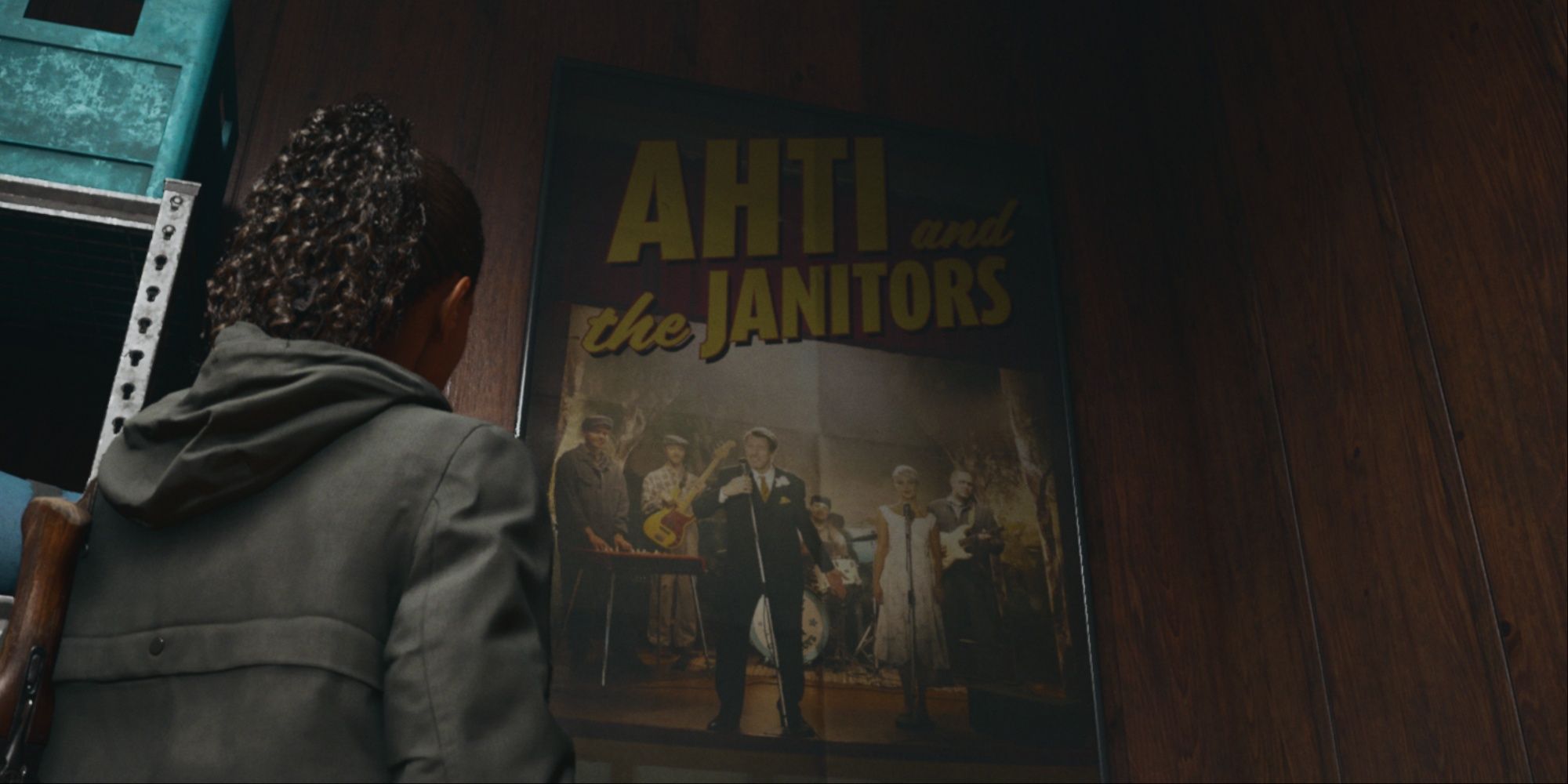 Saga staring up at a poster of Ahti's band, Ahti and the Janitos, with lead singer Ahti in a tux and the rest of the ensemble behind him playing instruments.