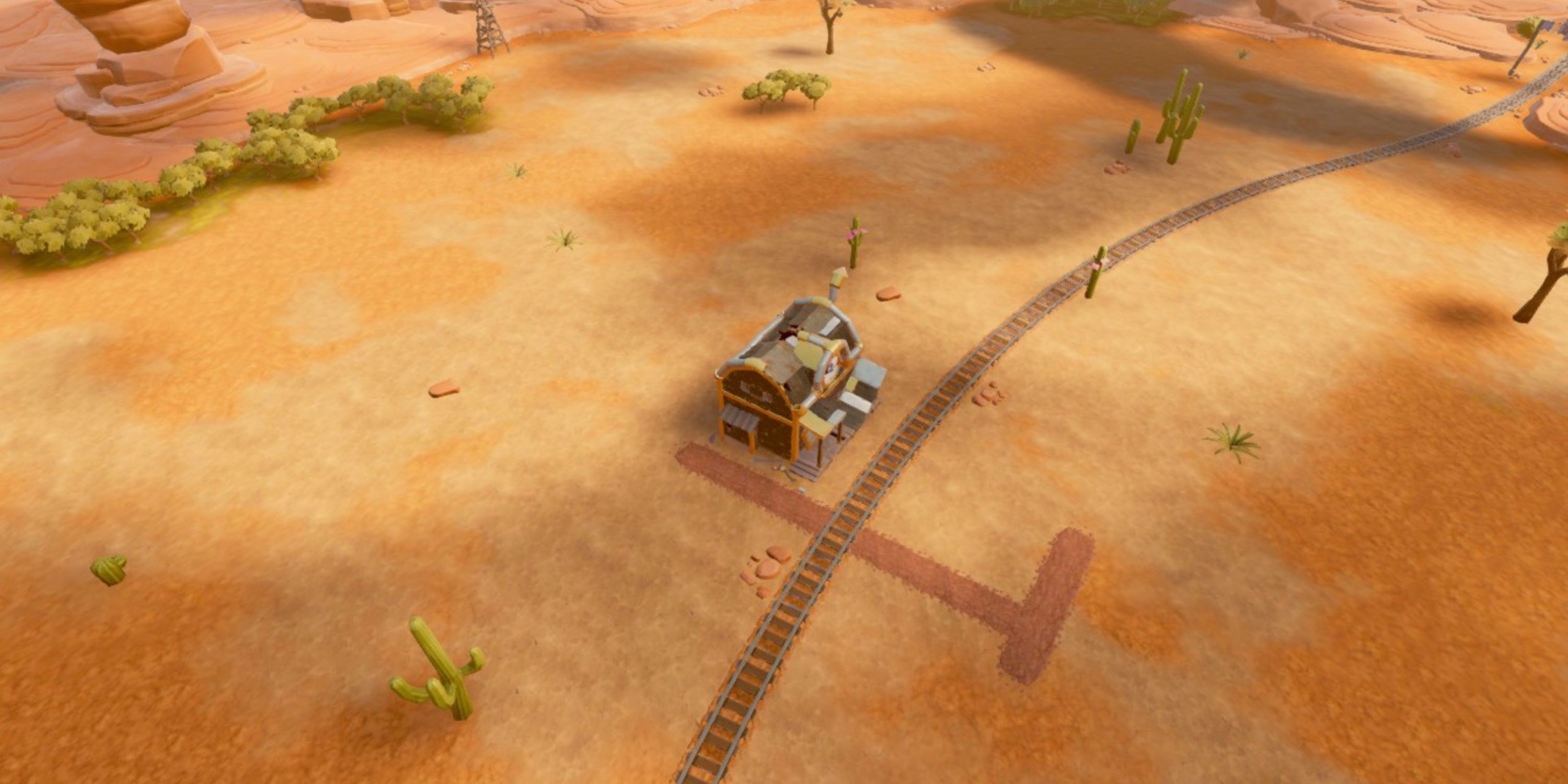 Aerial view of the Giddy-Up Gorge map, showing off the sparse forests and cacti and a few small rock formations in Steamworld Build.