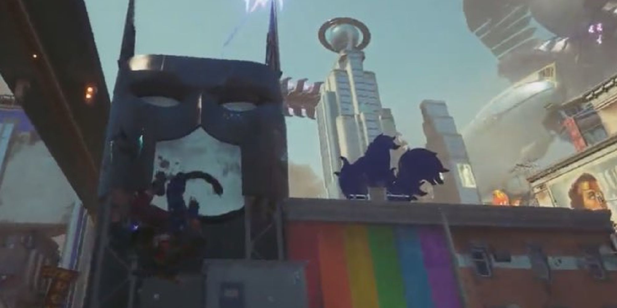 LGBT flag painted on a brick wall next to a building with a Batman mask in Metropolis in Suicide Squad Kills the Justice League