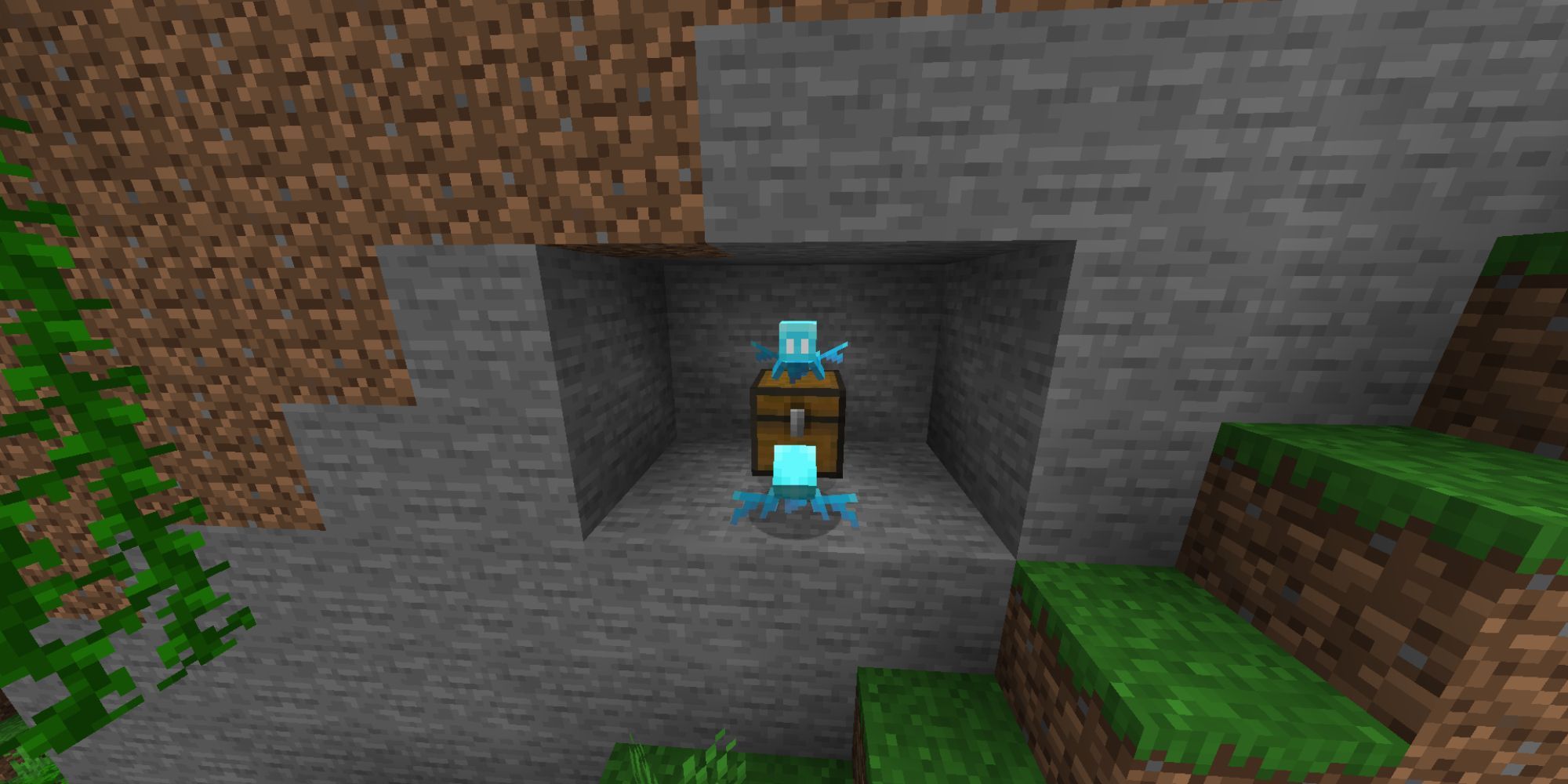 A pair of small, bright blue Allays hovering near a chest inside the wall of a mountain.
