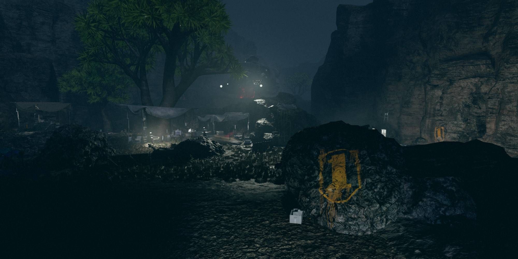 An encampment with a spray painted logo for the First.