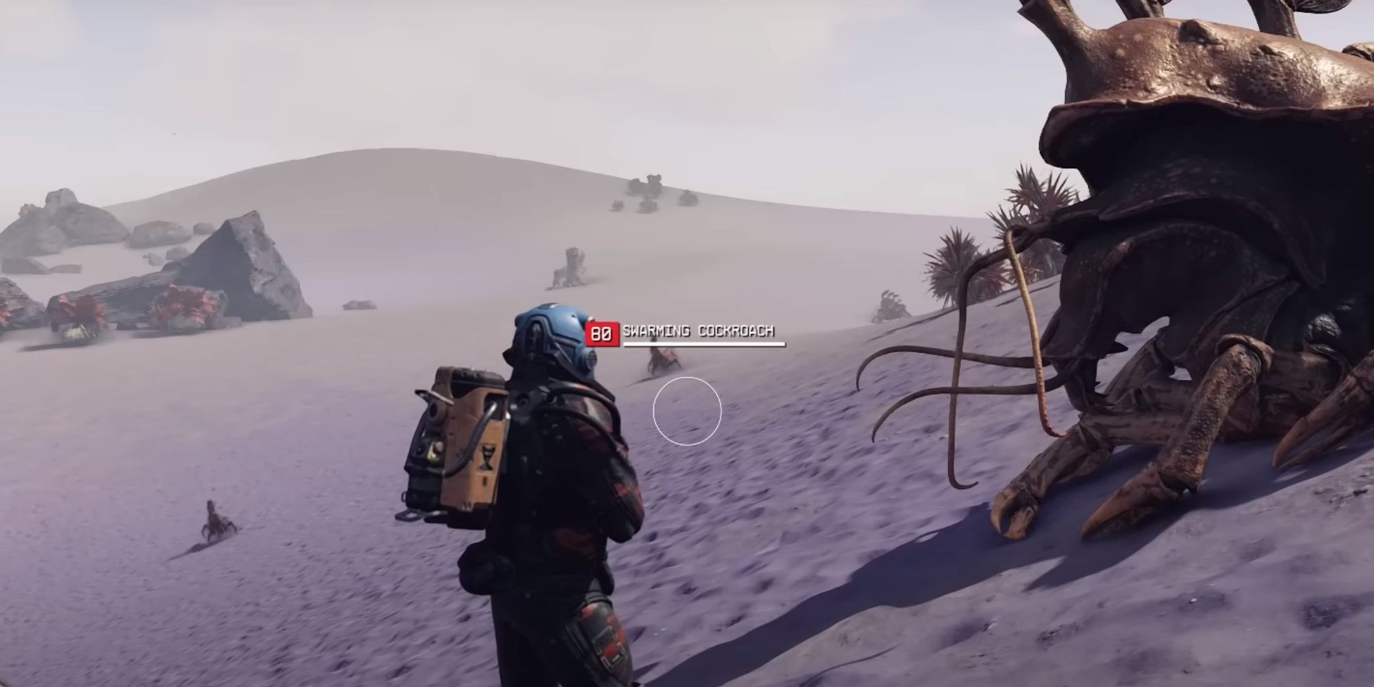 A few, mutated cockroach enemies seen in the distance on a sandy planet with a purple hue.