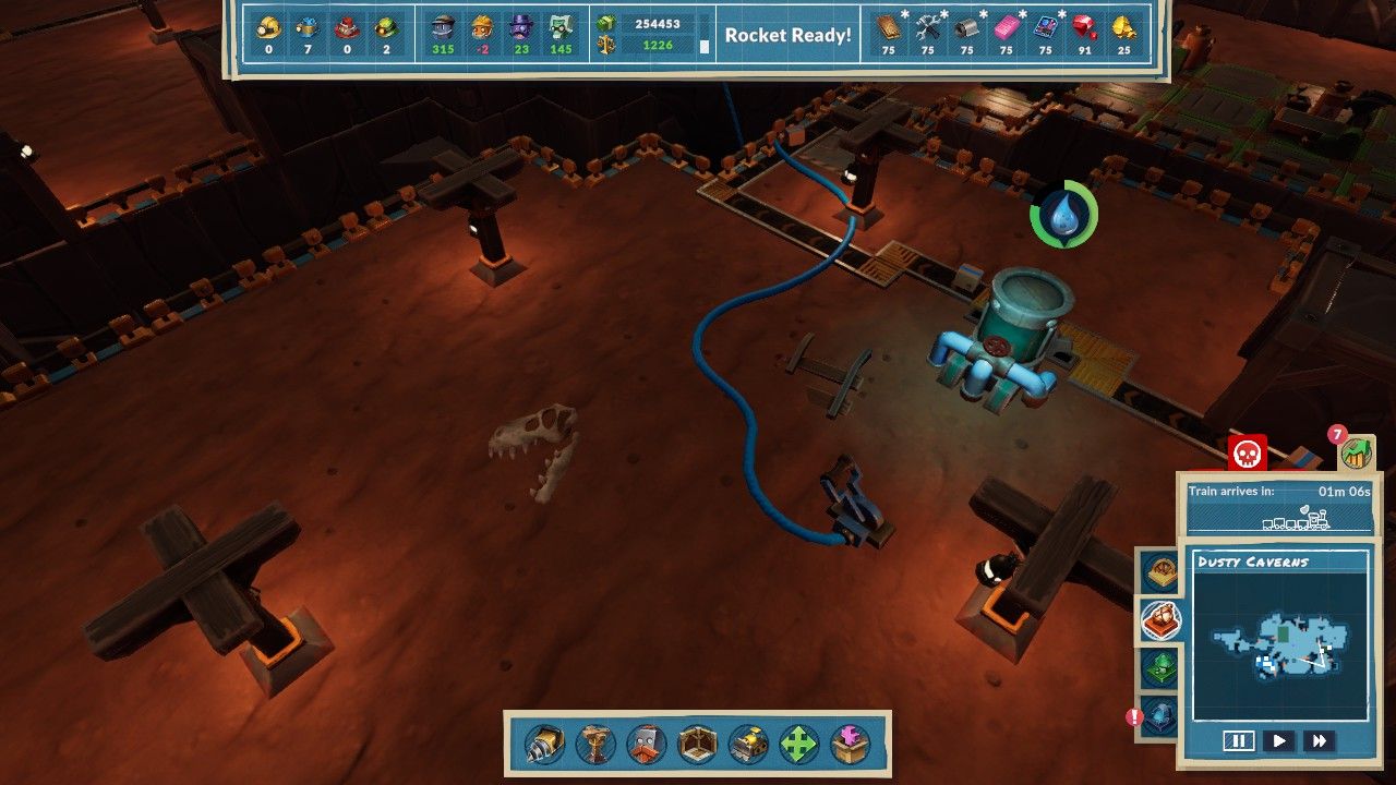 Several conveyor belts bringing goods away near a t.rex skull in the ground in Dusty Caverns in Steamworld Build.
