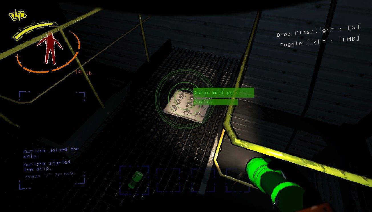 Player shining a flashlight on a small scrap called a cookie mold pan on the floor of a complex in Lethal Company. 