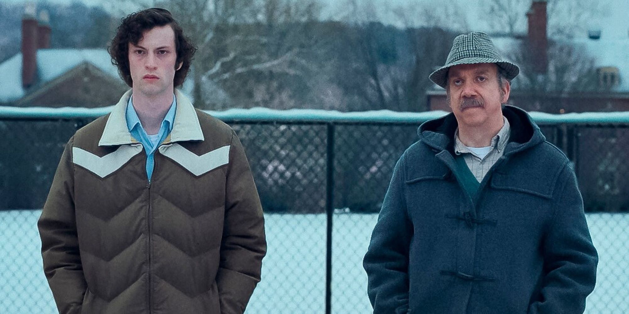 Dominic Sessa and Paul Giamatti in the snow in The Holdovers