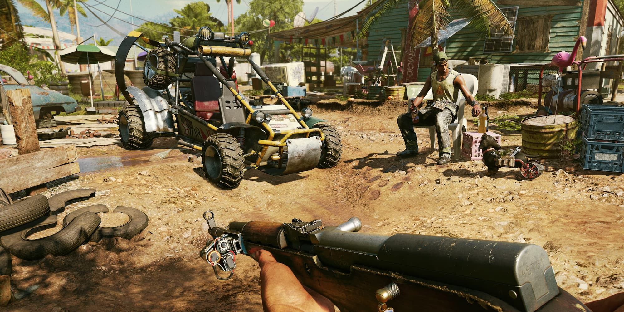 A player, holding a gun, approaches a settlement and a dune buggy in Far Cry 6.