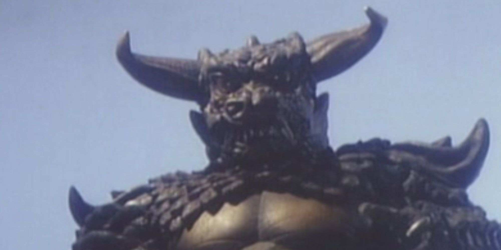 Pulgasari, a horned Kaiju looms over a low angle camera shot.