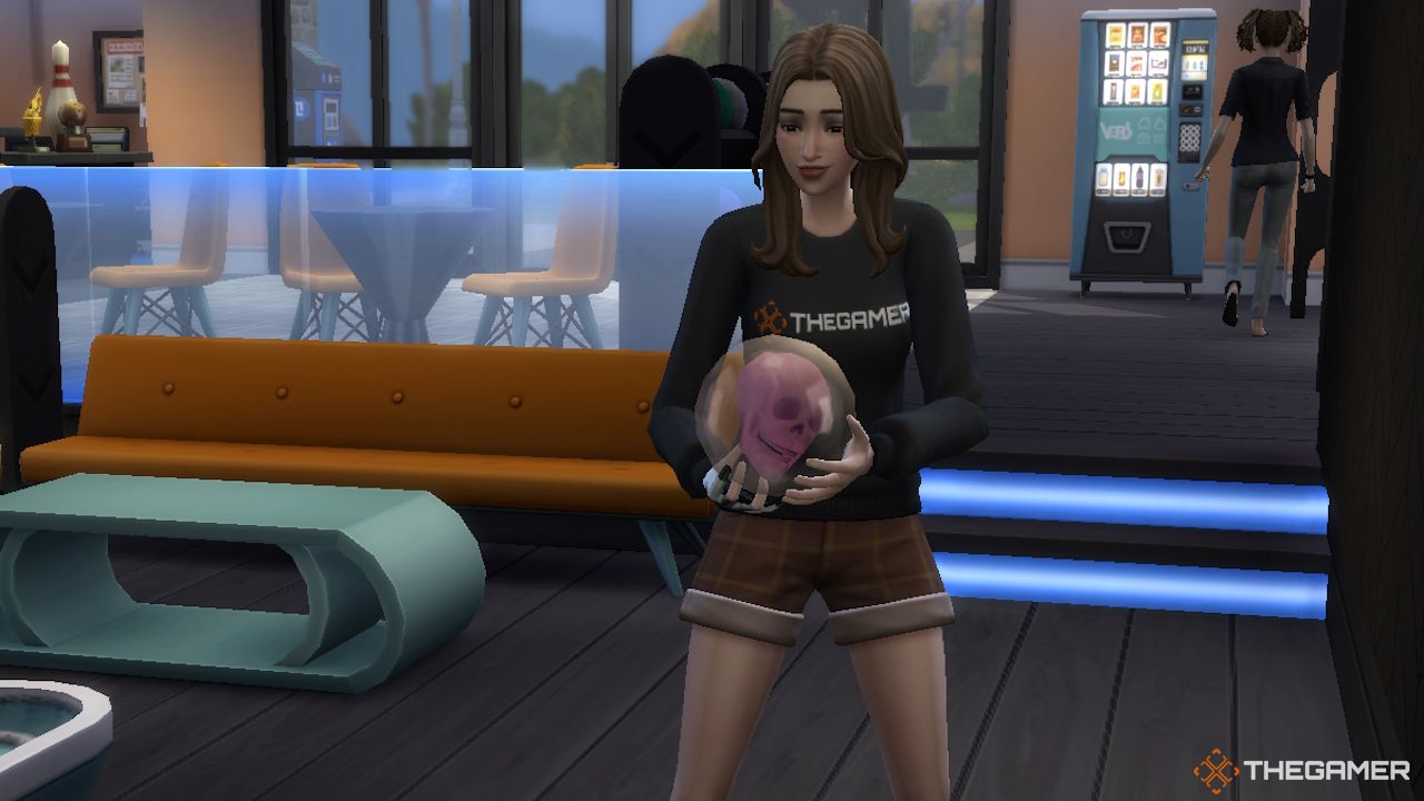 A female Sim holds a clear skull bowling ball in Sims 4