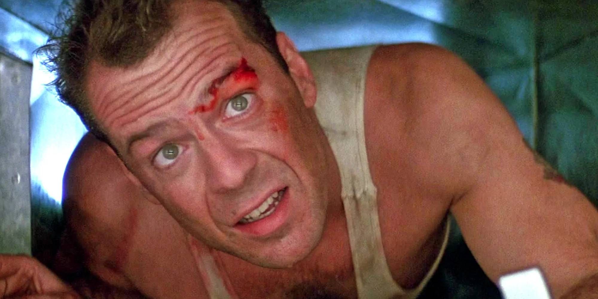 Bruce Willis as John McCaine from Die Hard looking up as he's in a vent
