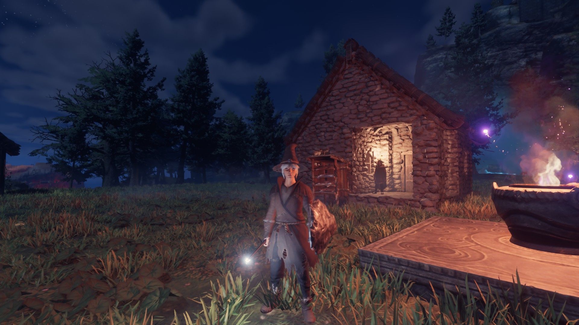 enshrouded player standing with wand in dark