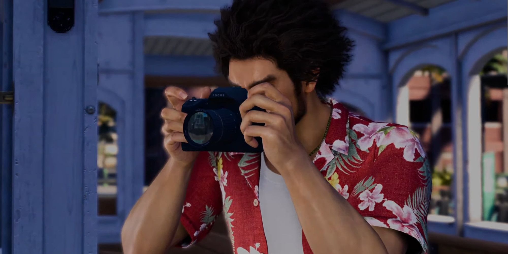 Ichiban Kasuga holding a camera up to his face in Infinite Wealth
