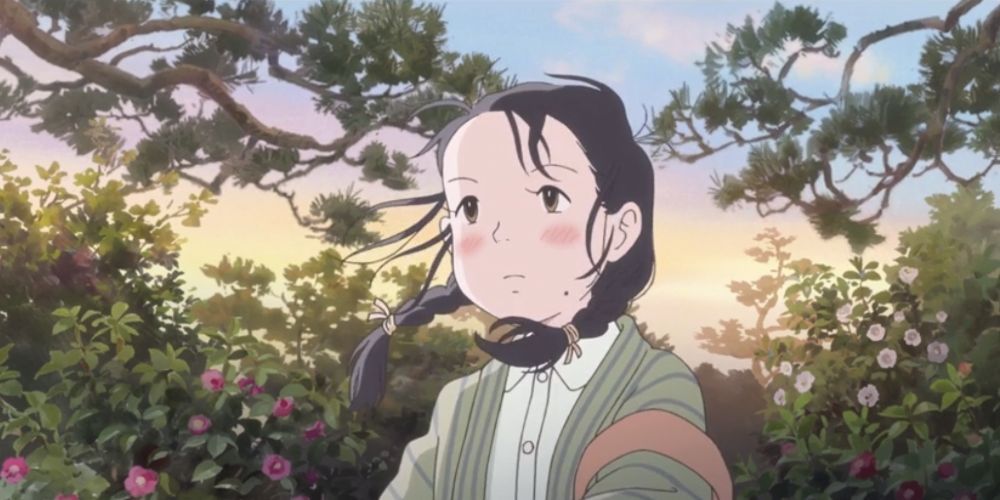 Suzu stands in a forest, her braids blowing in the wind