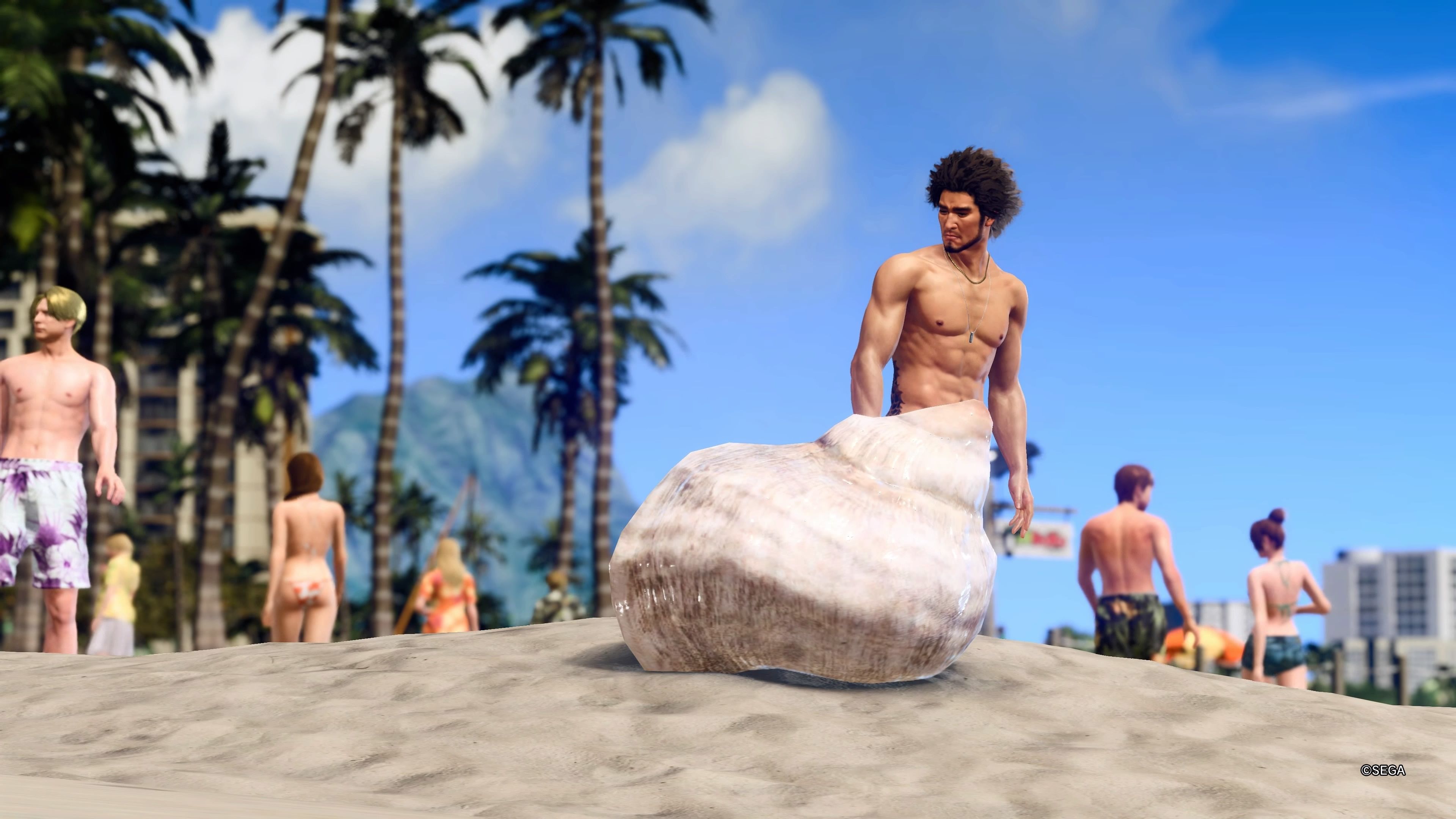 Kasuga naked on the beach with a shell in front of him in Like a Dragon Infinite Wealth.