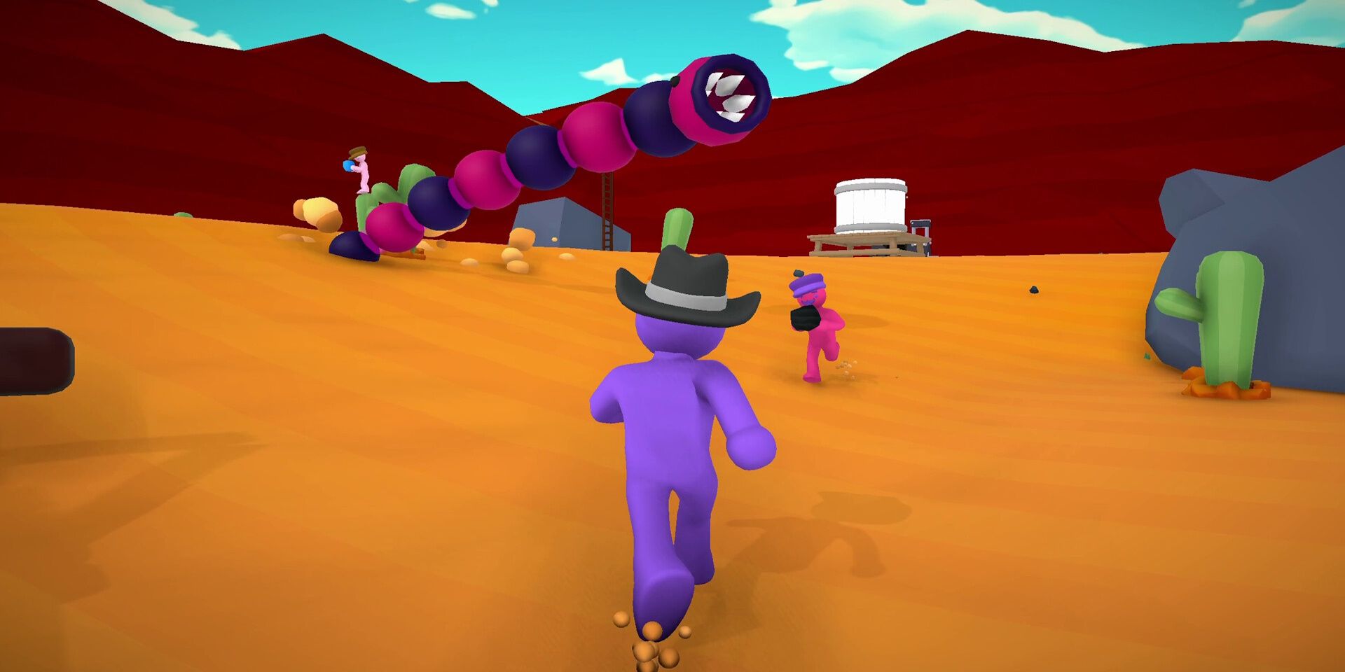 Last Train Outta Wormtown gameplay of players running from a sandworm that is jumping through the air